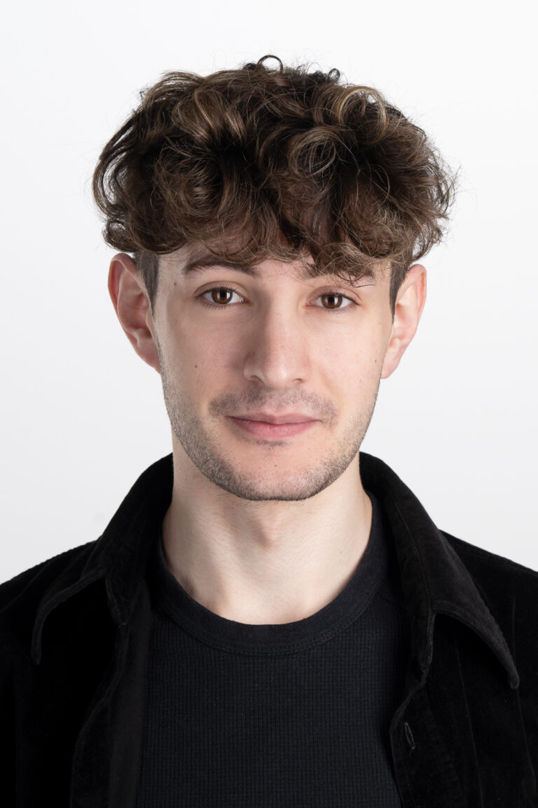 Headshot of Adelaide Actor Eddie in a black top